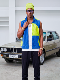 Blue and lime Bledlard fleece vest on male model — side view