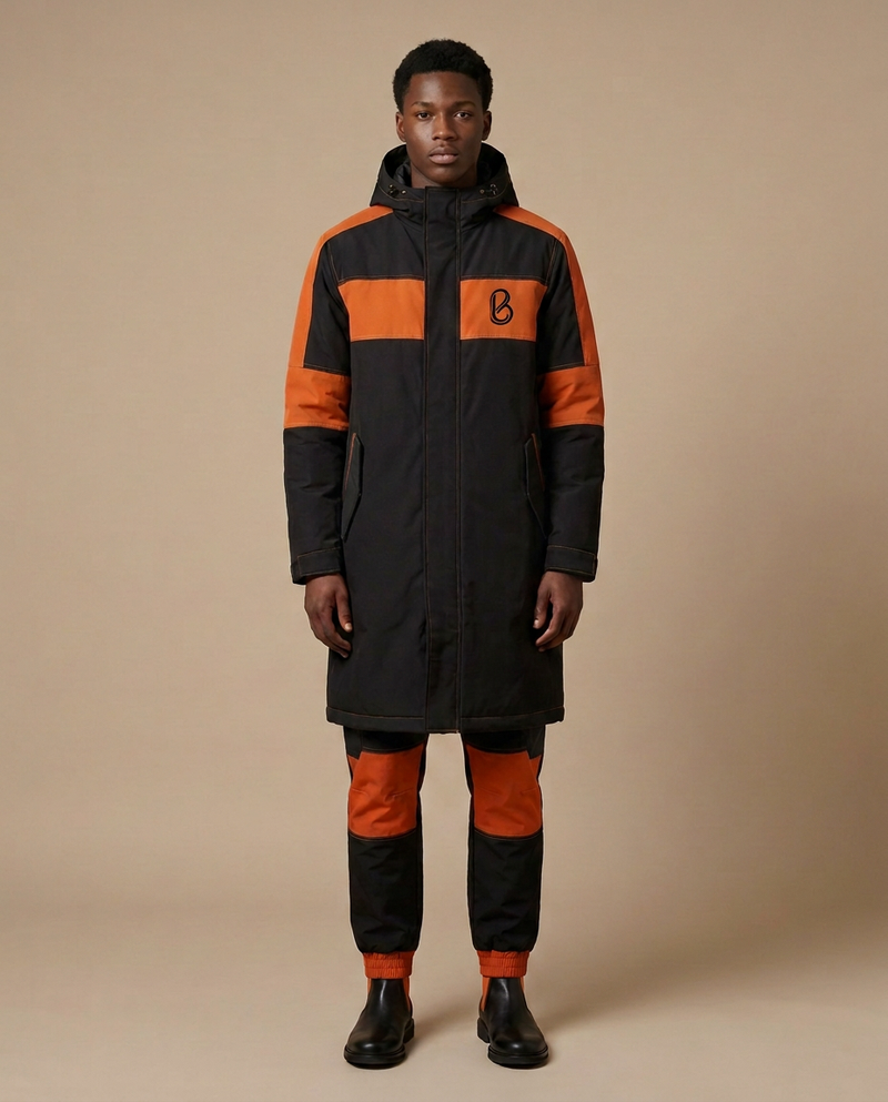 Bledlard Hooded Zip Outfit — long black hooded coat with burnt-orange panels and matching trousers, front view